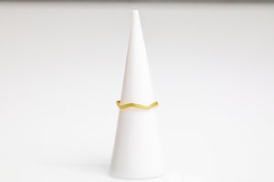 
                
                    Load image into Gallery viewer, A flattened guitar string ring. Plated in 14k gold, wavy shape, string texture. 
                
            
